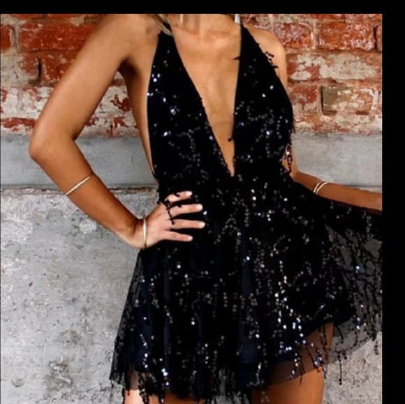 Dresses & Skirts - Stand out in this black sequined mini dress